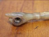 a small pipe that is sitting on a wooden table