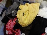 a basket full of clothes that is sitting on a table