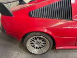 a red car that is parked in a garage
