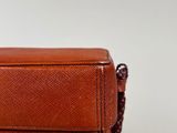 brown leather bag on white background with a brown cord