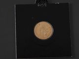 a close up of a coin on a black surface