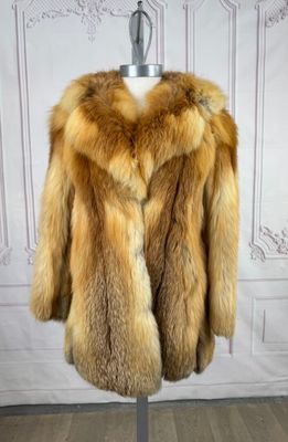 a close up of a fur coat on a mannequin stand
