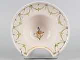 a close up of a bowl on a stand on a gray surface