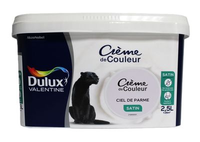 a tub of cream with a cat sitting on top of it