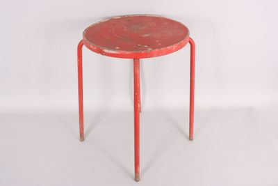 a small red table with a metal base and a red top