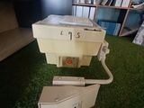 a toilet that is sitting on the grass in the room