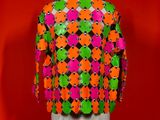 an image of a mannequin wearing a colorful jacket on a mannequin