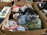 a cardboard box filled with clothes and other items