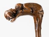 a statue of a man holding a dog on a stick