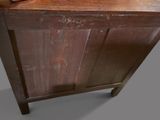 an old wooden cabinet with a bowl on top of it