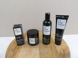 three bottles of body care sitting on a wooden tray
