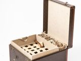 an old suitcase with a lot of compartments inside of it