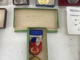 several medals and medals displayed on a table in a display case