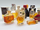 several different types of perfume bottles sitting on top of a white surface