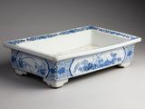 a blue and white bowl with a bird design on it