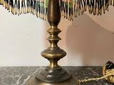 a lamp that is sitting on a table with a rope