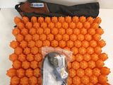 a close up of a bag of orange balls on a white surface