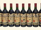 six bottles of red wine lined up in a row on a white background