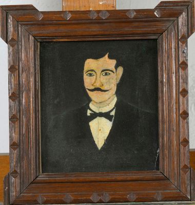 painting of a man in a tuxedo with a mustache in a wooden frame