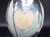 a vase that has a picture of a woman on it
