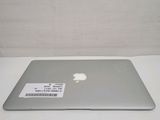 an apple laptop computer sitting on top of a white table