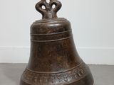 an old bronze bell with a cross on top of it