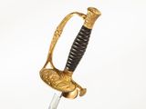 an old sword with a gold handle on a white background