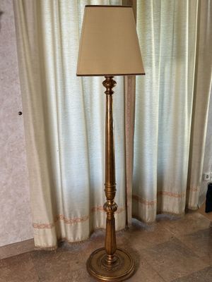 a lamp that is sitting on the floor next to a window