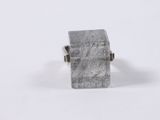a close up of a silver ring on a white surface