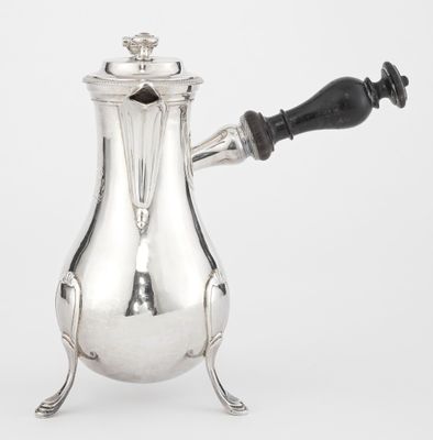 an antique silver coffee pot with a black handle on a white background