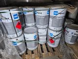 several cans of paint are stacked on a pallet in a warehouse