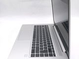 a silver laptop computer sitting on a white surface
