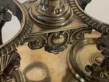 a silver plate with a clock on top of it