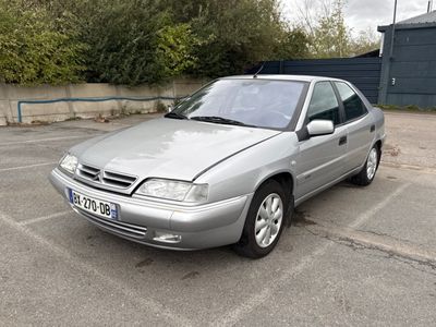 a silver car that is parked in a parking lot