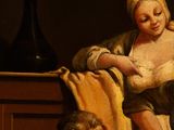 an image of a painting of a woman holding a baby and a man sitting at a table