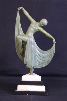 a bronze statue of a woman holding a scarf on top of a marble base