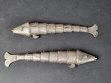 pair of antique silver fish figurines with turquoise eyes