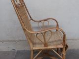 a wicker chair that is sitting on the concrete floor