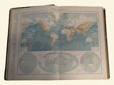 an open book with a map of the world on it