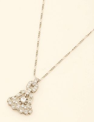 a white gold and diamond necklace with a heart shaped pendant