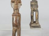three wooden figurines of a man and a woman on a clear base
