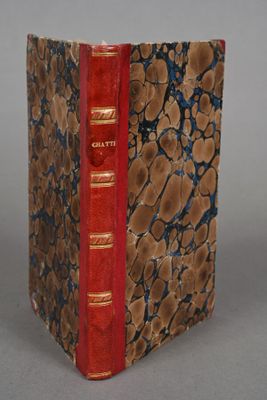 a book that is sitting on a table with a red cover