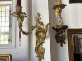 two candles that are on the wall next to a picture