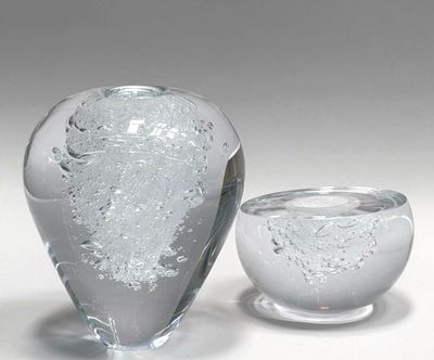 two glass vases sitting next to each other on a table