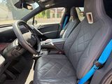 the interior of a car with a blue seat belt and a black steering wheel