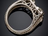 a close up of a silver ring on a black surface