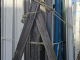 several pieces of metal are stacked on top of each other in front of a building