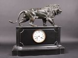 a statue of a lion on top of a clock