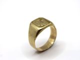 a close up of a gold ring on a white surface