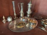 a silver plate with silver objects on it on a table